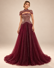 The Estelle Embellished Cape Evening Gown - Burgundy full view warm beige studio photograph